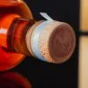 adhesive tear strip attached to a bottle