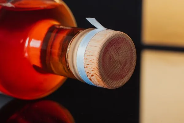 adhesive tear strip attached to a bottle